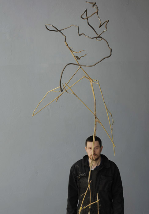 Artist in front of Francis and Hashish, 2013, steel, bronze, oil paint, wood, 305 x 100 x 100 cm, photo by: Filip Zawada/courtesy of BWA Wrocław
